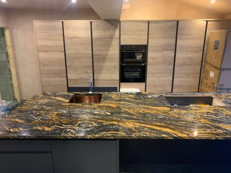 Cosmic Gold Granite black with heavy gold veins running through installed in Astley Manchester