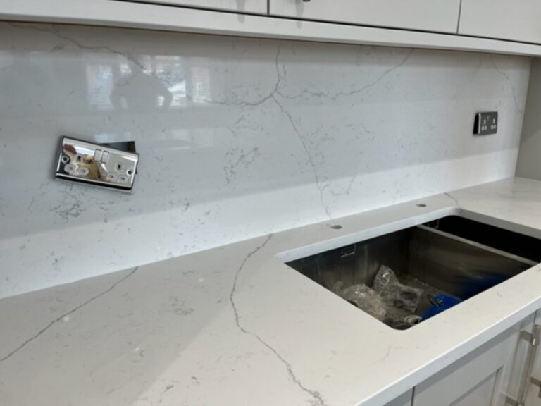 Fugen Avalanche worktop and full height splash back with socket cut outs installed in Atherton Manchester