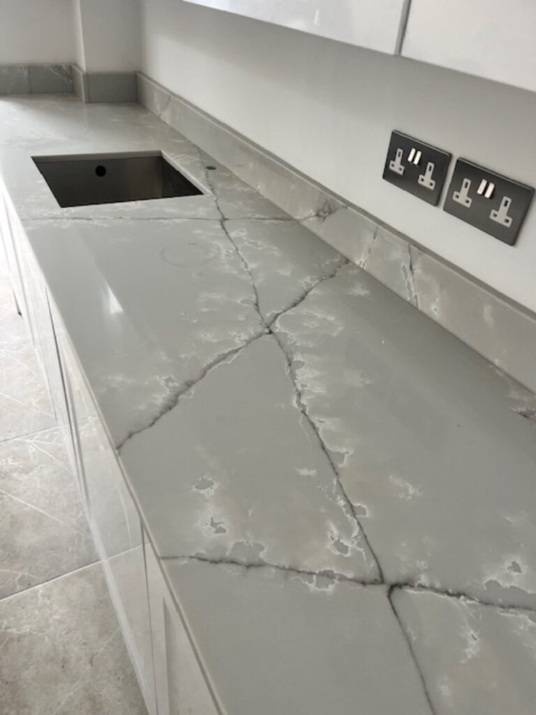 Ice white quartz worktops with a matching upstand installed in Bolton Westhoughton