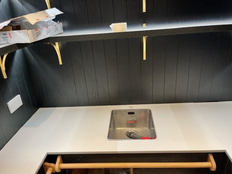 Suoer white quartz in 20 mm thickness installed with a flush mounted sink and brass handles in Bury Lancashire